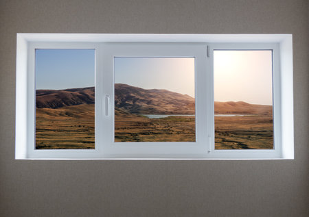 View from the window of the house on a beautiful sunset in the mountains
