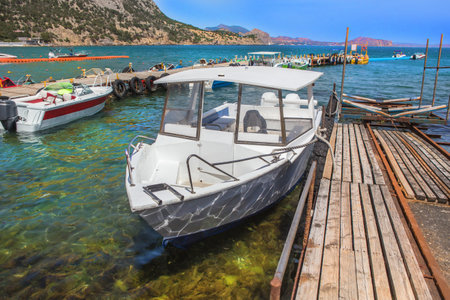 Motor boats at the pier on the seashore on summer dayの写真素材