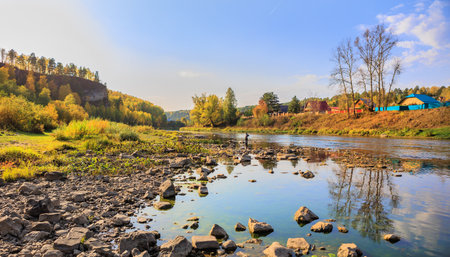 Rocky river bank in the mountains on an autumn day