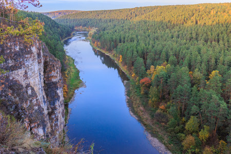 High stone rocky river bank in autumn forestの写真素材