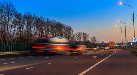 Car traffic in the evening on a suburban highway. blurred motionの写真素材