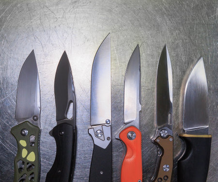 Various knives on a metal surface