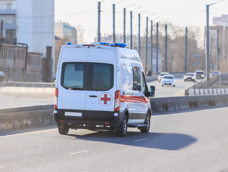 Ambulance car driving down the city streetの写真素材