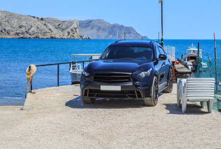 SUV on the pier near the boats near the sea lagoonの写真素材