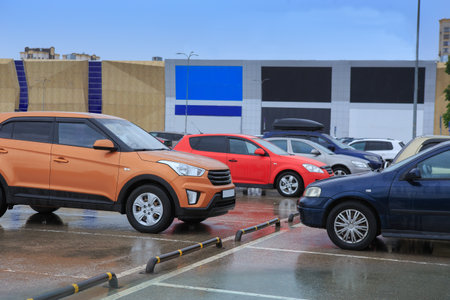 Cars in the parking lot at the mall in the rainの写真素材