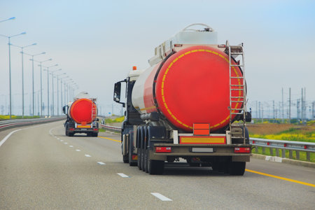 Petrol trucks move along a suburban highwayの写真素材