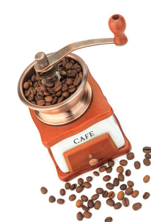 Mechanical coffee grinder with coffee beans on a white backgroundの写真素材