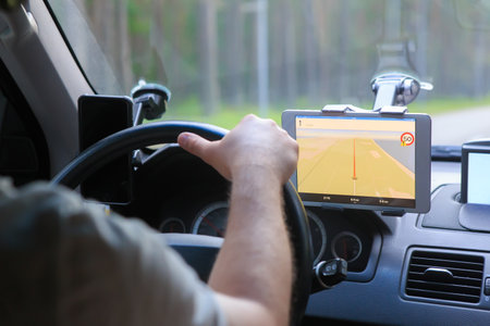 Driver Moves in the Car guided by the navigator on the tabletの写真素材
