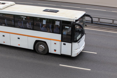 Tourist Bus is moving down the street in the cityの写真素材