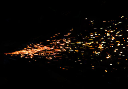 Bright Sparks of metal against dark backgroundの写真素材