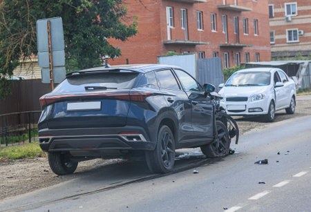 Car accident. Black broken SUV by the side of the roadの写真素材