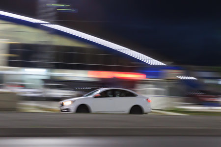 Car drives through the night city, blurred motionの写真素材