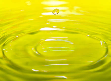 yellow drop fall in waterの写真素材