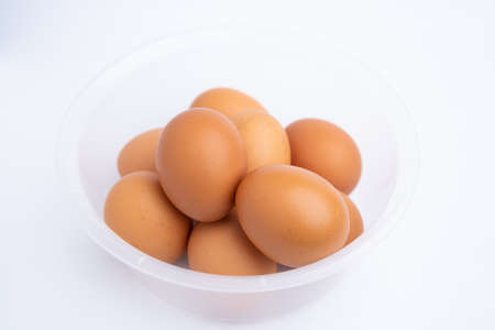 Eggs in a bowl isolated on white backgroundの写真素材