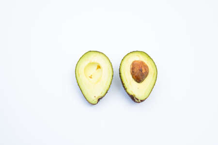 Two slices of avocado isolated on the white background. One slice with core.の写真素材