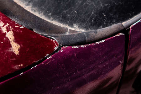 Scratched metal surface painted in red and purple colorの写真素材