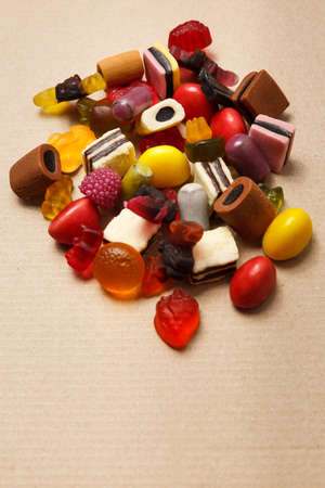 Gummy marmelade candies on old paper background top viewの写真素材
