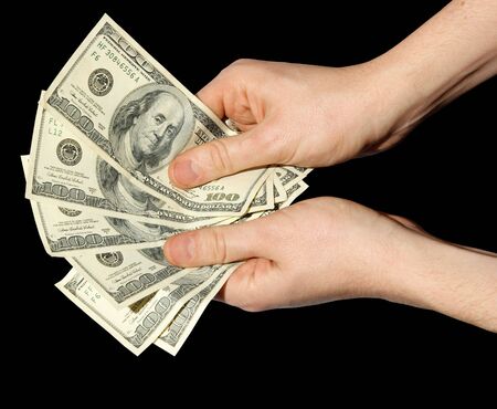Money in a hand on a black background