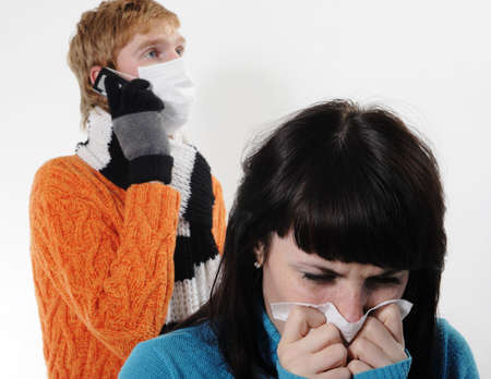 girl was ill of influenza, a man stands behind a mask, said by telephone, A(H1N1)の写真素材