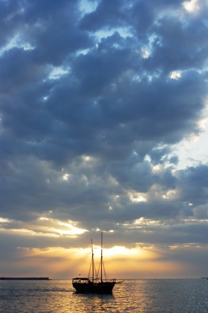 silhouette of the yacht at sunset, natureの写真素材