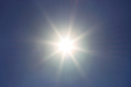 Bright sun in blue sky, backgroundの写真素材