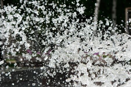 Water splashed against a dark backgroundの写真素材