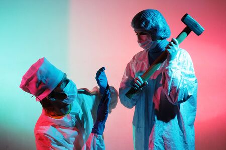 Doctors with a sledgehammer on a abstract dirty colored backgroundの写真素材