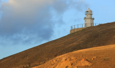 Lighthouse  The movement of clouds on the mountain Meganom, Crimea, Ukraineの写真素材