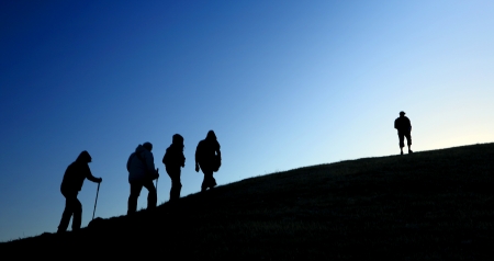 Group of tourists take to the mountains  Silhouetteの写真素材