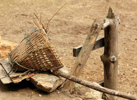 Old Nepalese basket rests on a stone. Nepal.の写真素材
