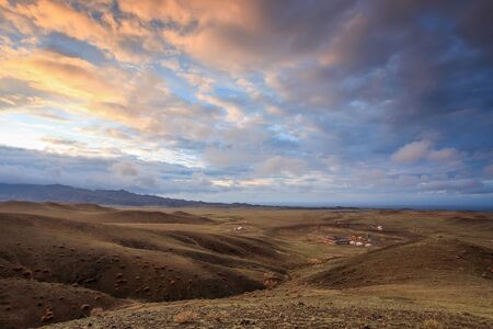 Colorful sunset over the mountains Gurvan Saikhan of southern Mongolia.の写真素材