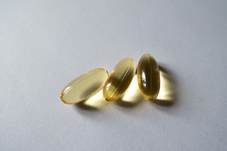 Close up of three sofgels of evening primrose oilの写真素材