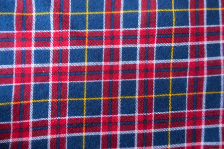 Textile with plaid pattern in red, blue and white