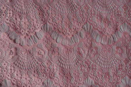 Warm pink ornamental lacy fabric from aboveの写真素材