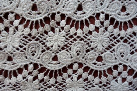 Macro of white lace with floral pattern from aboveの写真素材
