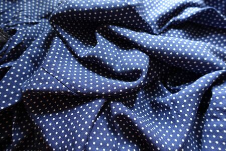 Wrinkled fabric in blue and white with polka dot printの写真素材