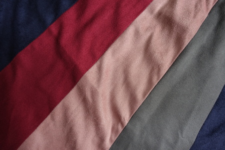 Diagonal strips of blue, red, pink, grey artificial suede