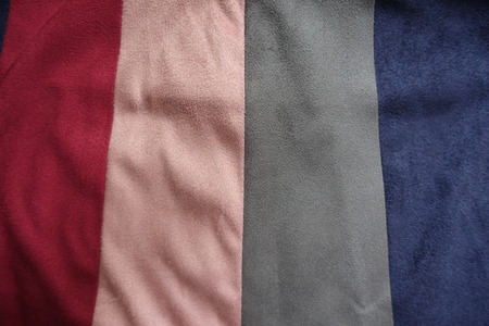 Vertical strips of red, pink, grey and blue artificial suedeの写真素材