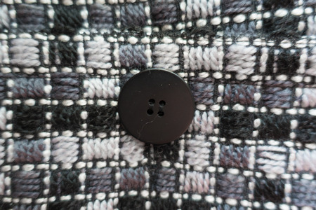 Button sewn to thick grey coat fabricの写真素材