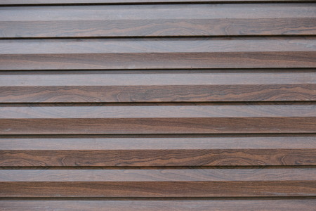 Chocolate brown timber wall of polished planks