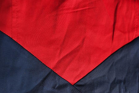 Triangular seam between red and dark blue cottonの写真素材
