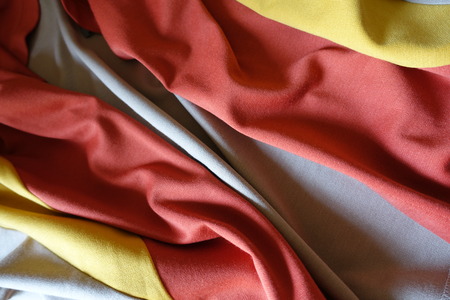 Folded orange, yellow and beige jersey fabric