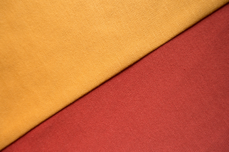 Golden yellow and orange red jersey sewn together (diagonal)の写真素材