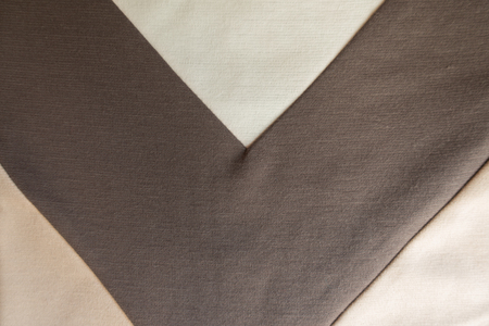 V shaped brown stripe sewn to beige fabric