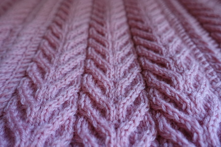 Close shot of pink knitted fabric with pleats pattern
