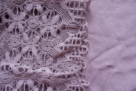 Retro styled lace on simple puce viscose fabricの写真素材