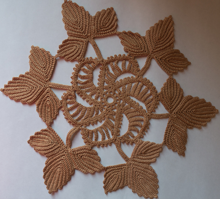 Homemade beige circular crochet doily from above