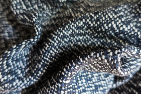 Draped blue, black and white tweed fabric