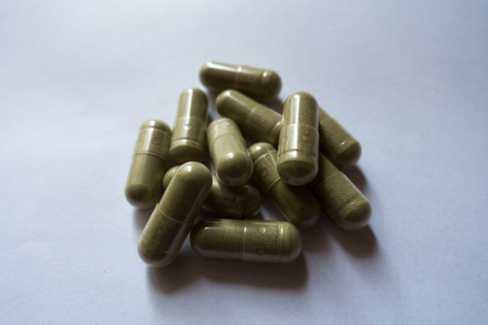 Capsules of moringa powder in a heapの写真素材