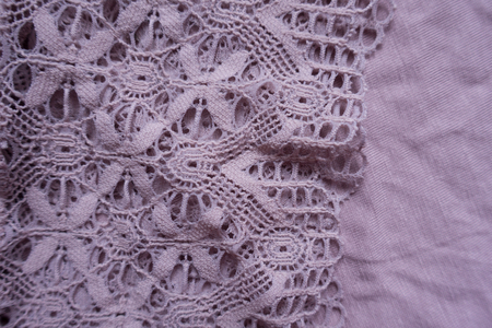 Old fashioned lace on simple puce viscose fabricの写真素材